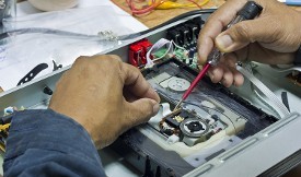 Hands Performing Restoration on Older Hardware